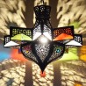 Octagonal star lamp of openworked bronzed iron and colored glass